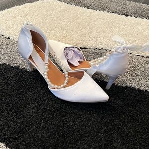White satin heel and satin bow pearl ankle strap.
